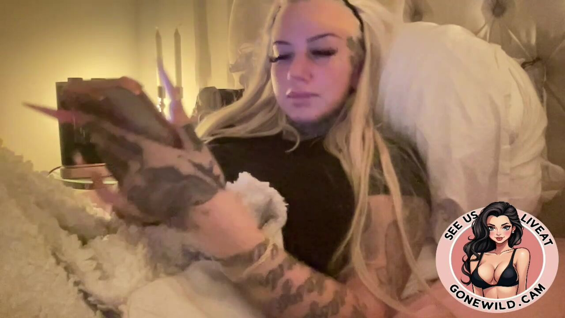 Inked Blonde Bombshell Holding Toys in Bed - tattoo - blonde - solo - tease - bedroom - toys - long nails - inked - masturbation - softcore